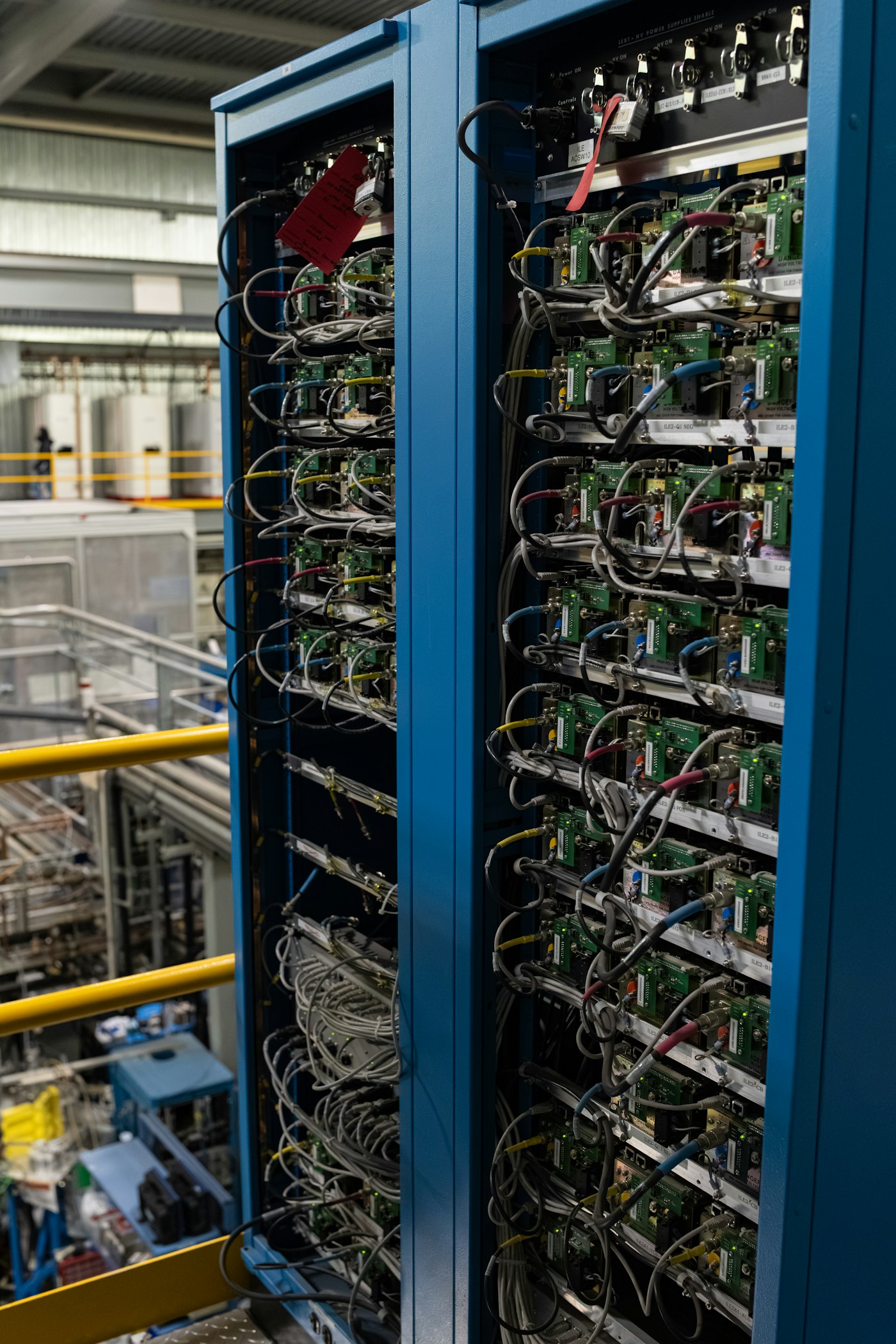 Rows of server racks and wiring in a data center environment.