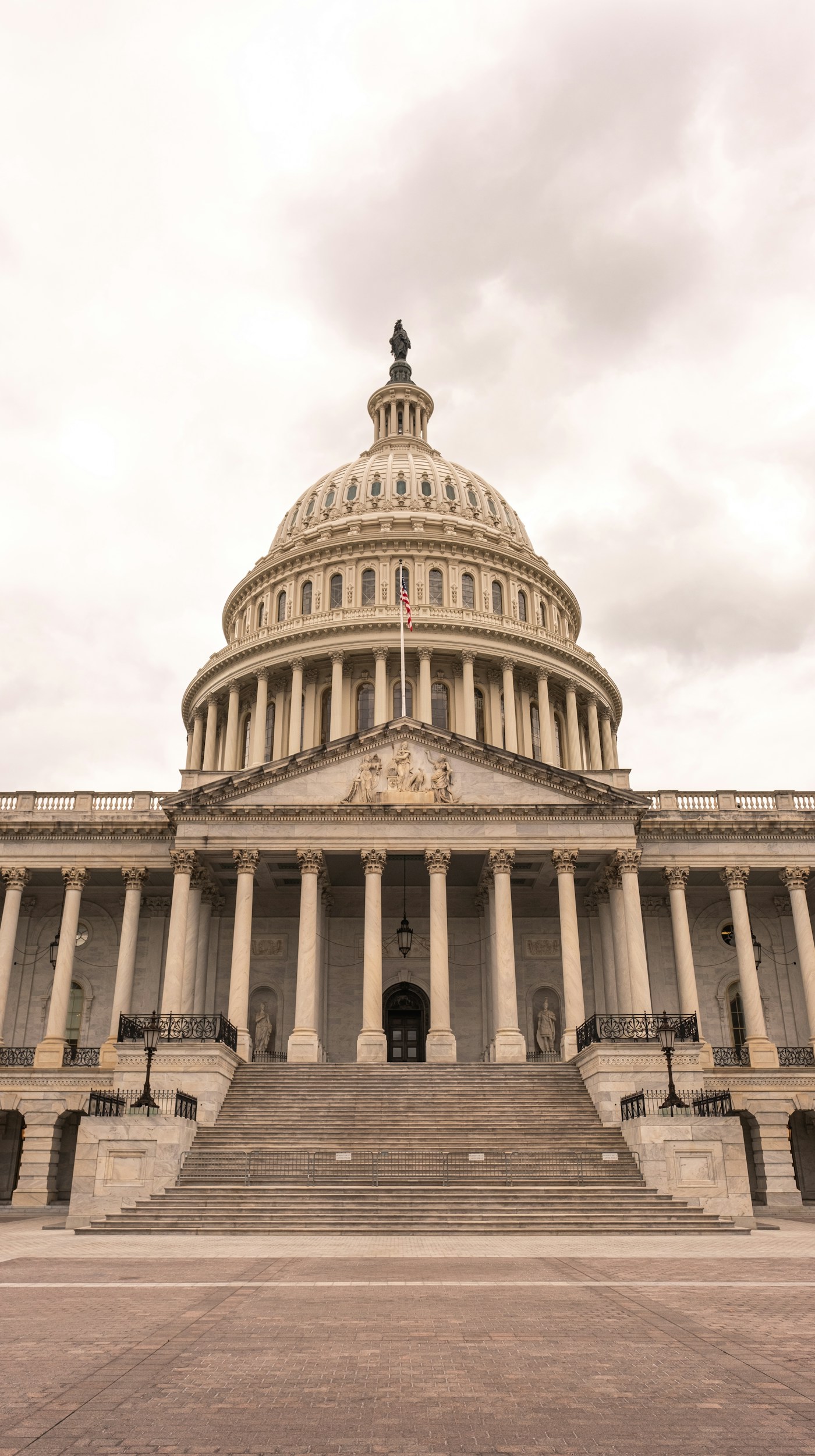 United States Capitol building under a cloudy sky.